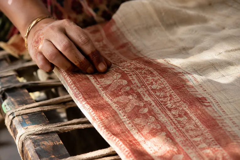 Close up of handwoven cotton saree texture showing natural weave irregularity