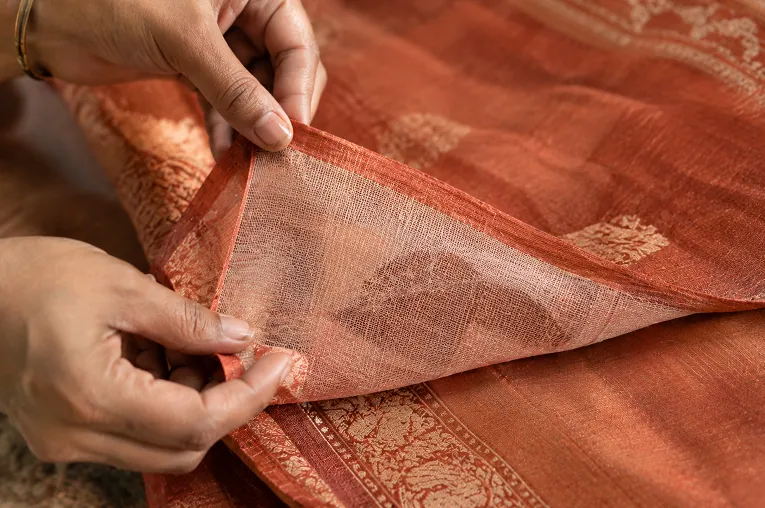 Checking the reverse side of a saree to identify handloom weaving versus power loom