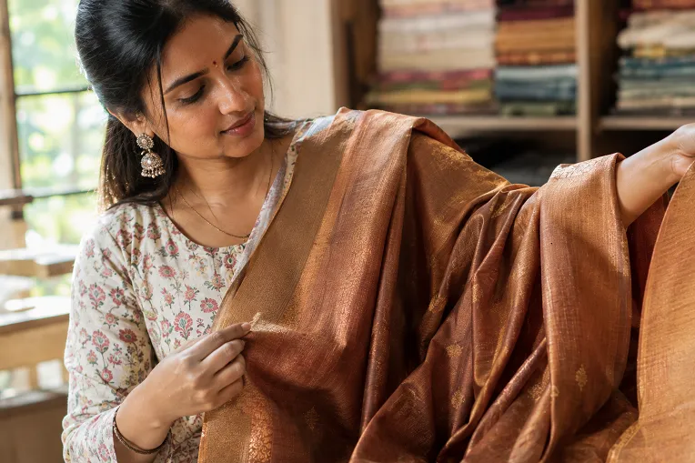 Feeling the natural drape and softness of a handloom saree to check its authenticity