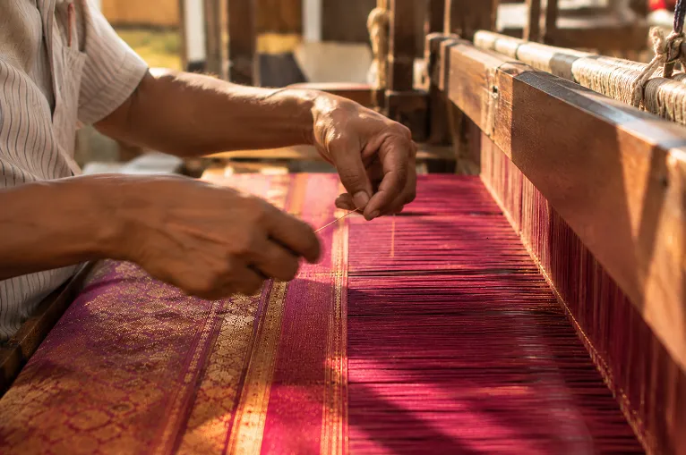 partially completed silk saree on a loom showing the time investment behind handweaving