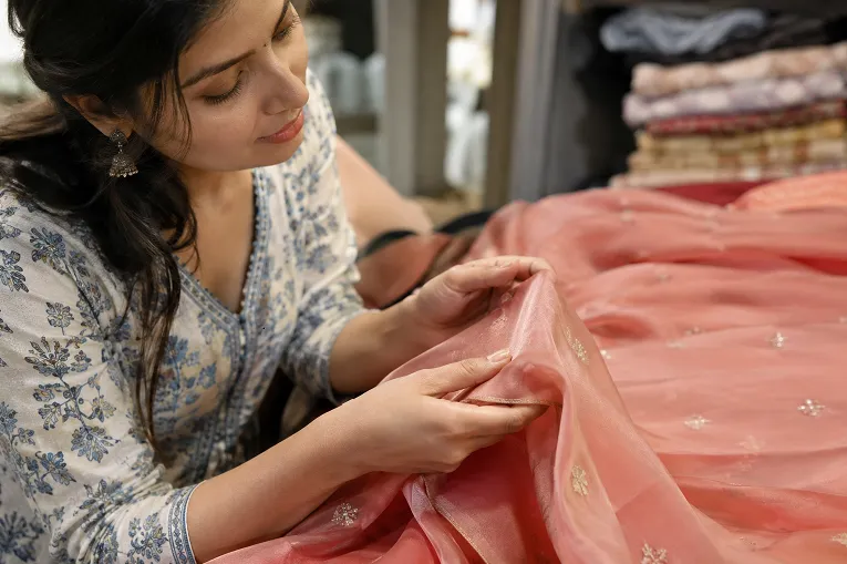 Testing lehenga fabric weight and structure with a hand feel check