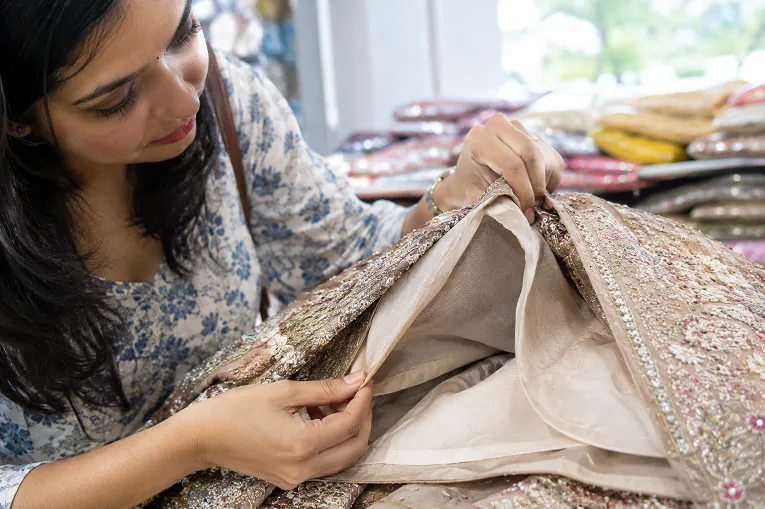 Checking the inner lining quality at a lehenga waistband before buying