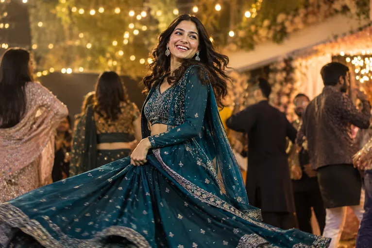 Woman spinning in a georgette lehenga at a sangeet, one of the multi day wedding outfits that needs to move well