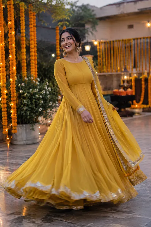 Woman twirling in a wide-flare georgette Anarkali to show how hem sweep affects movement
