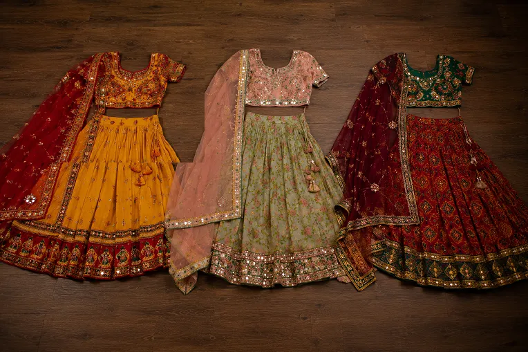 Three chaniya choli outfits showing cotton georgette and raw silk fabric differences for Navratri