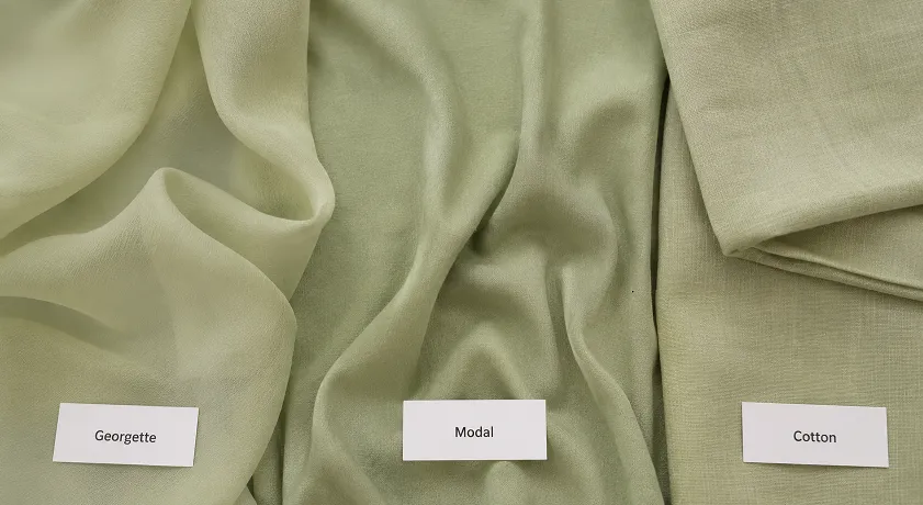 Close-up comparison of georgette, modal, and cotton fabric swatches showing different textures for salwar kameez