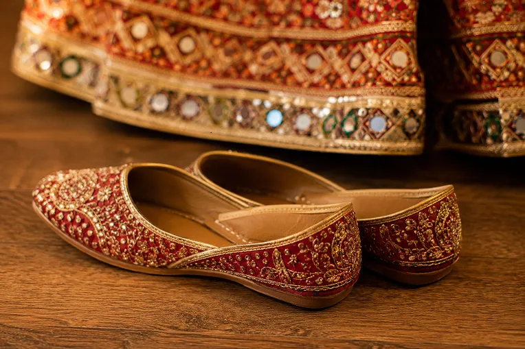 Red and gold embroidered jutti mojari with chaniya choli hem for Navratri garba outfit
