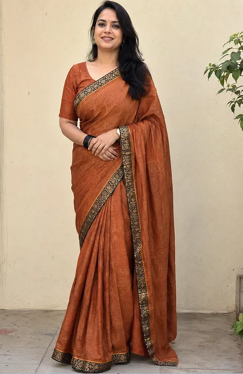 Woman with rectangle body shape wearing a tussar saree with contrast border in seedha pallu drape