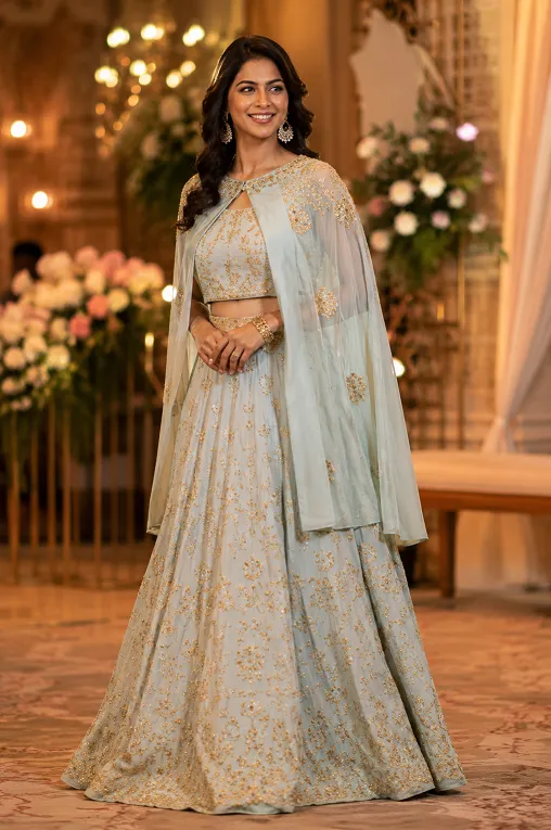 Cape-style structured blouse layered over a lehenga for a pear shaped body