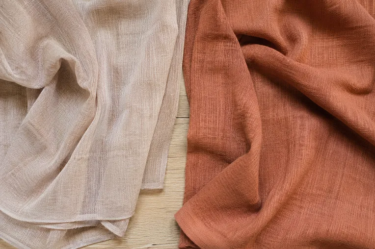 Lightweight and heavyweight linen saree fabric compared side by side to show GSM difference