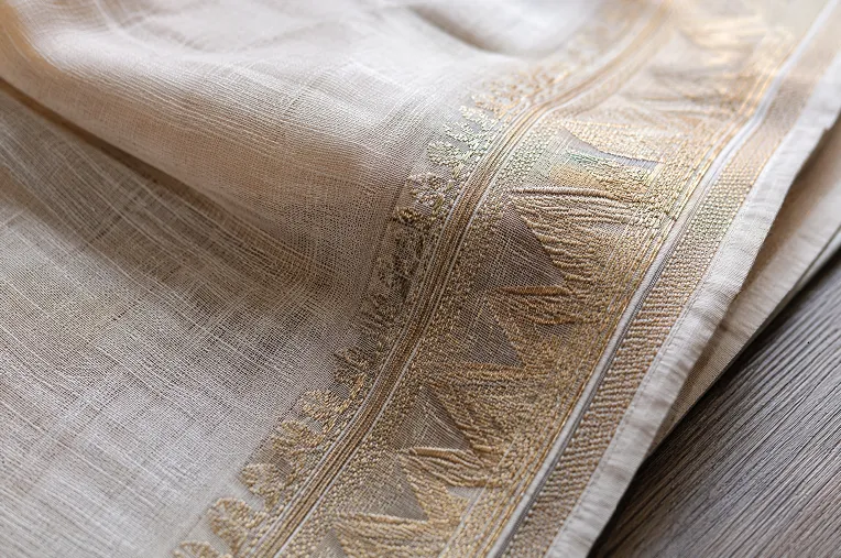 Close up of linen saree woven border showing thread density used to check fabric quality