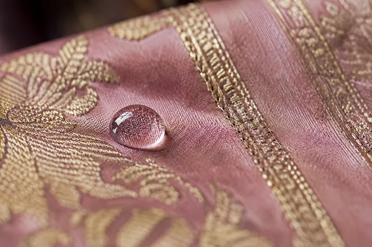 water droplet on silk saree zari work showing monsoon damage risk