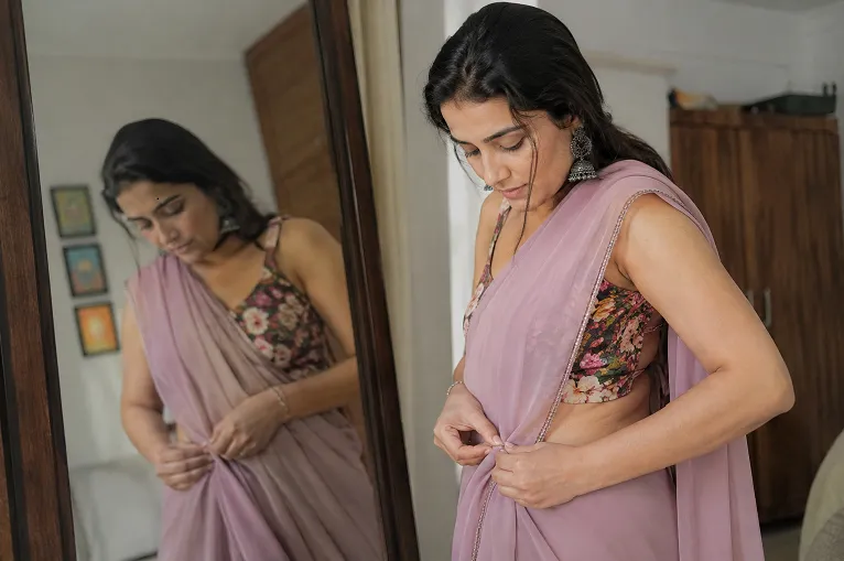 chiffon saree being pinned in place over a non-slip petticoat
