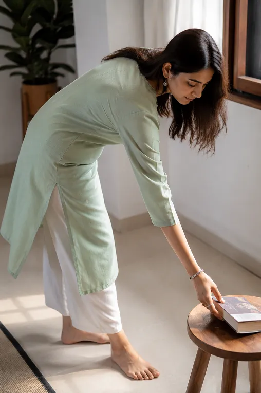 woman testing kurti fit by bending forward to check for riding up or pulling