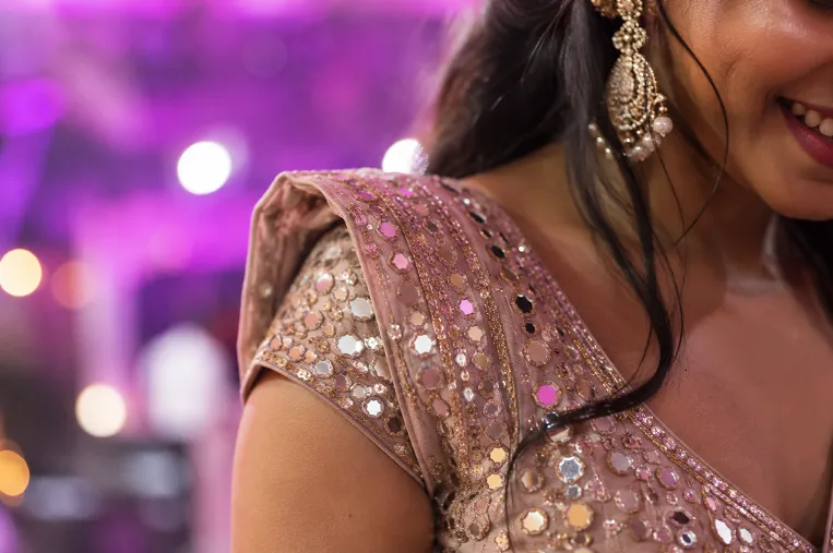 mirror work and sequin embellishment catching sangeet stage lighting
