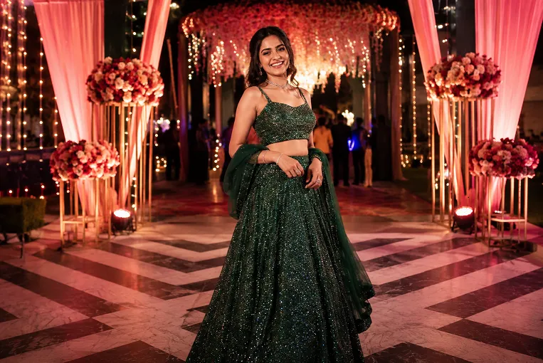 sangeet outfit ideas featured image, woman in embellished lehenga