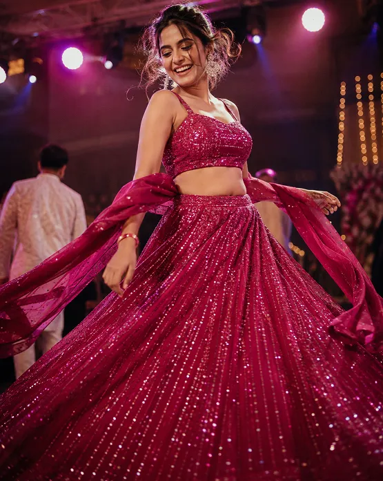 woman dancing at sangeet in embellished lehenga, sangeet outfit ideas