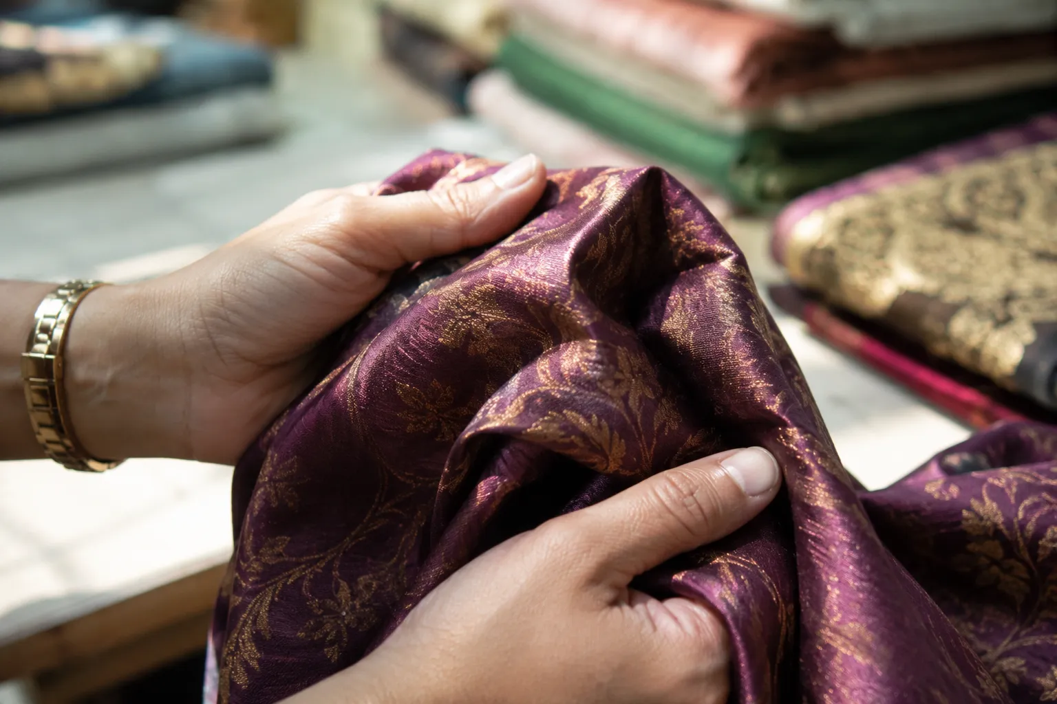 Close up of hands checking fabric quality before buying a traditional dress