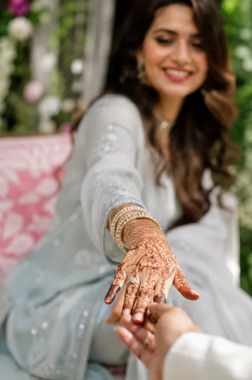 bride's hand and sleeve detail during ring exchange moment